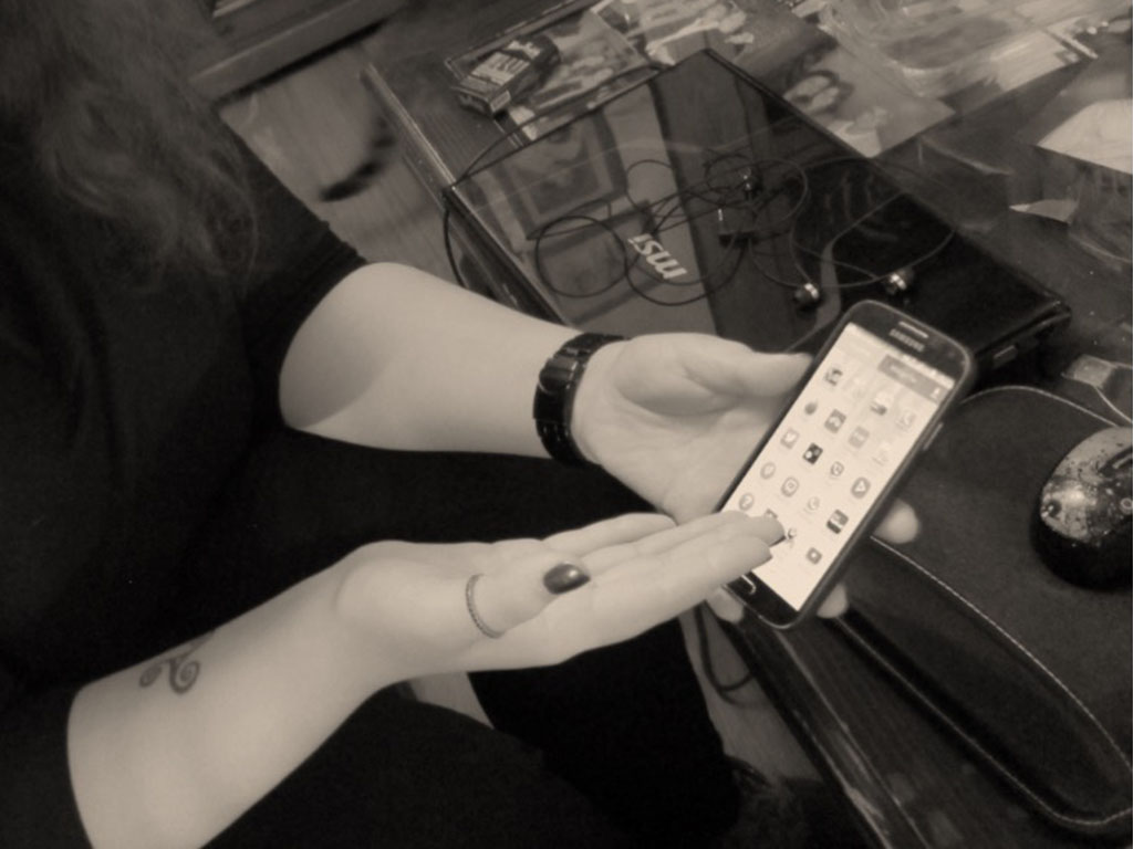 Person using a smartphone to report abuse, representing identity verification and online safety research